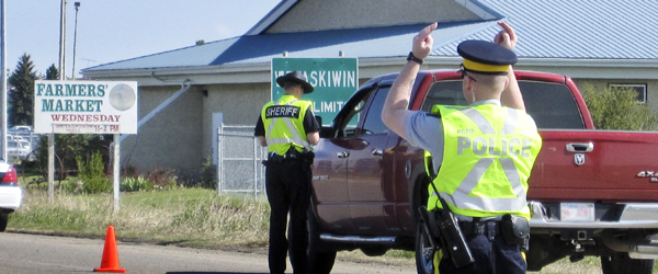 RCMP Traffic Services and Alberta Sheriffs conducting a Check Stop