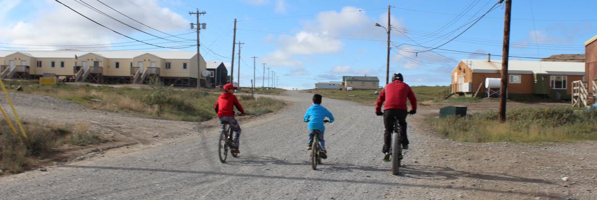 Three children riding bikes.