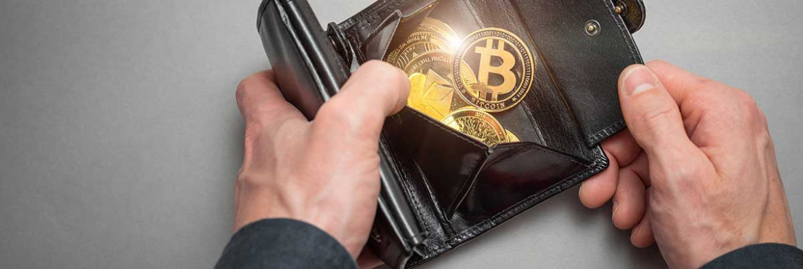 Hands open a wallet containing cryptocurrency
