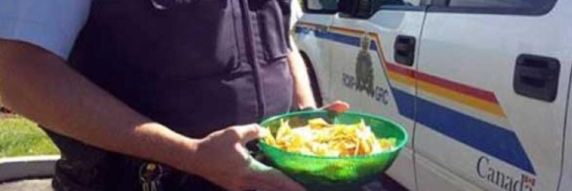 Police officer with bowl of chips.