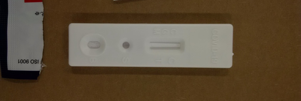 A medical swab kit with the words COVID-19 written on the side.